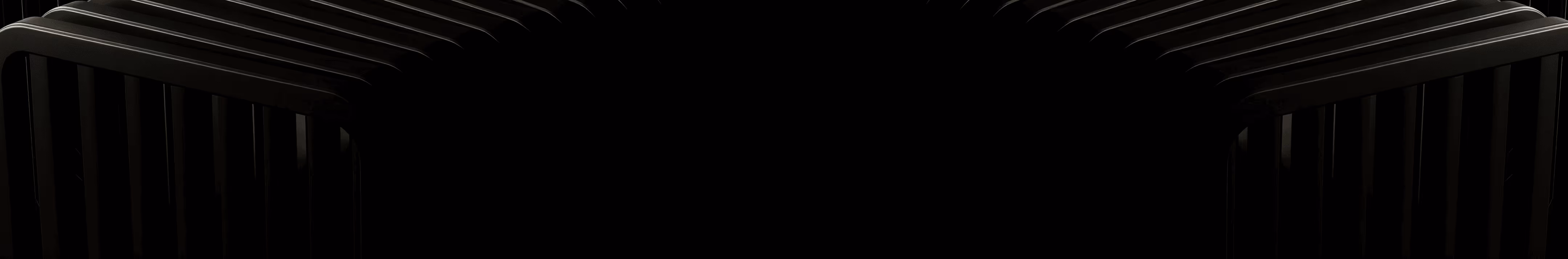 Two black chairs with vertical slats viewed from the side against a black background.