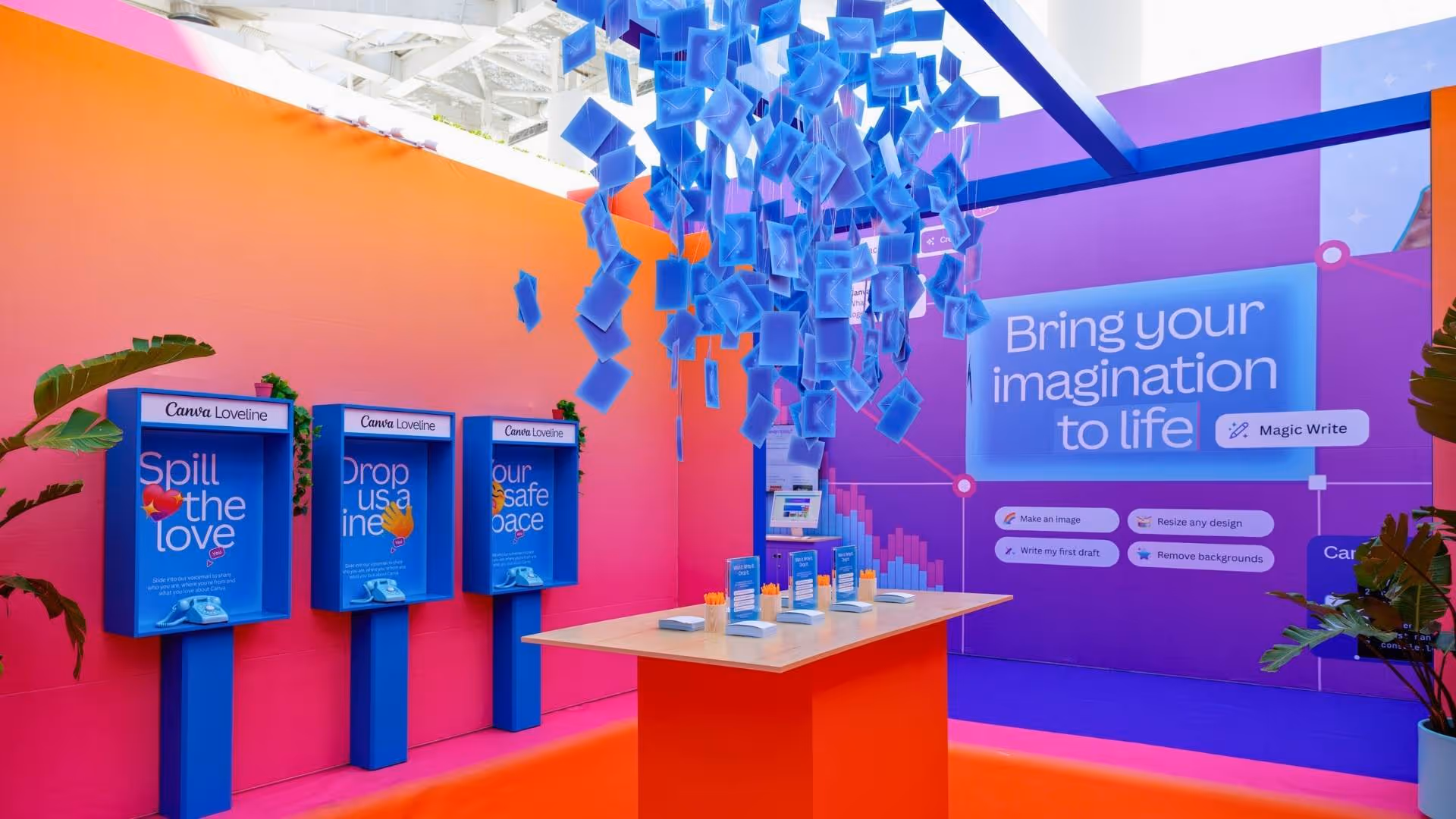 Colorful room with blue phone booths, a red table with pencils, and floating blue digital cards above.