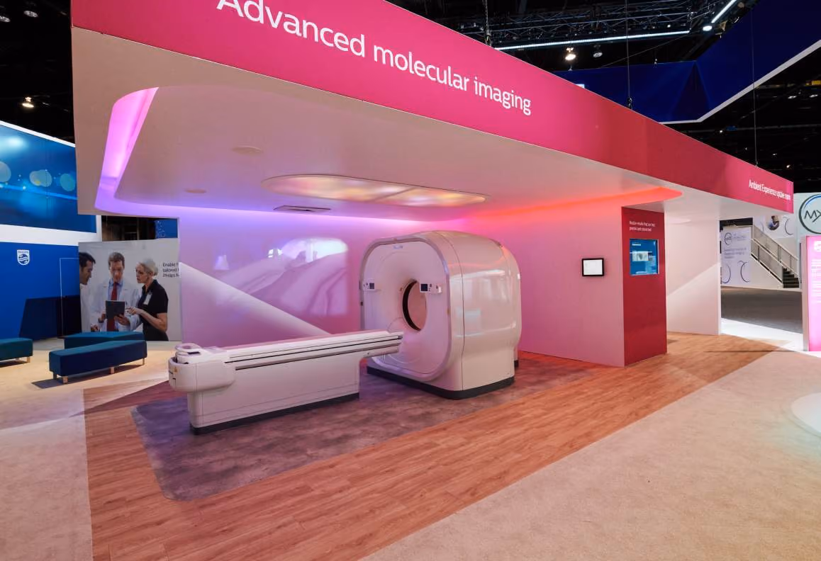 Modern medical imaging scanner displayed under pink signage reading Advanced molecular imaging.