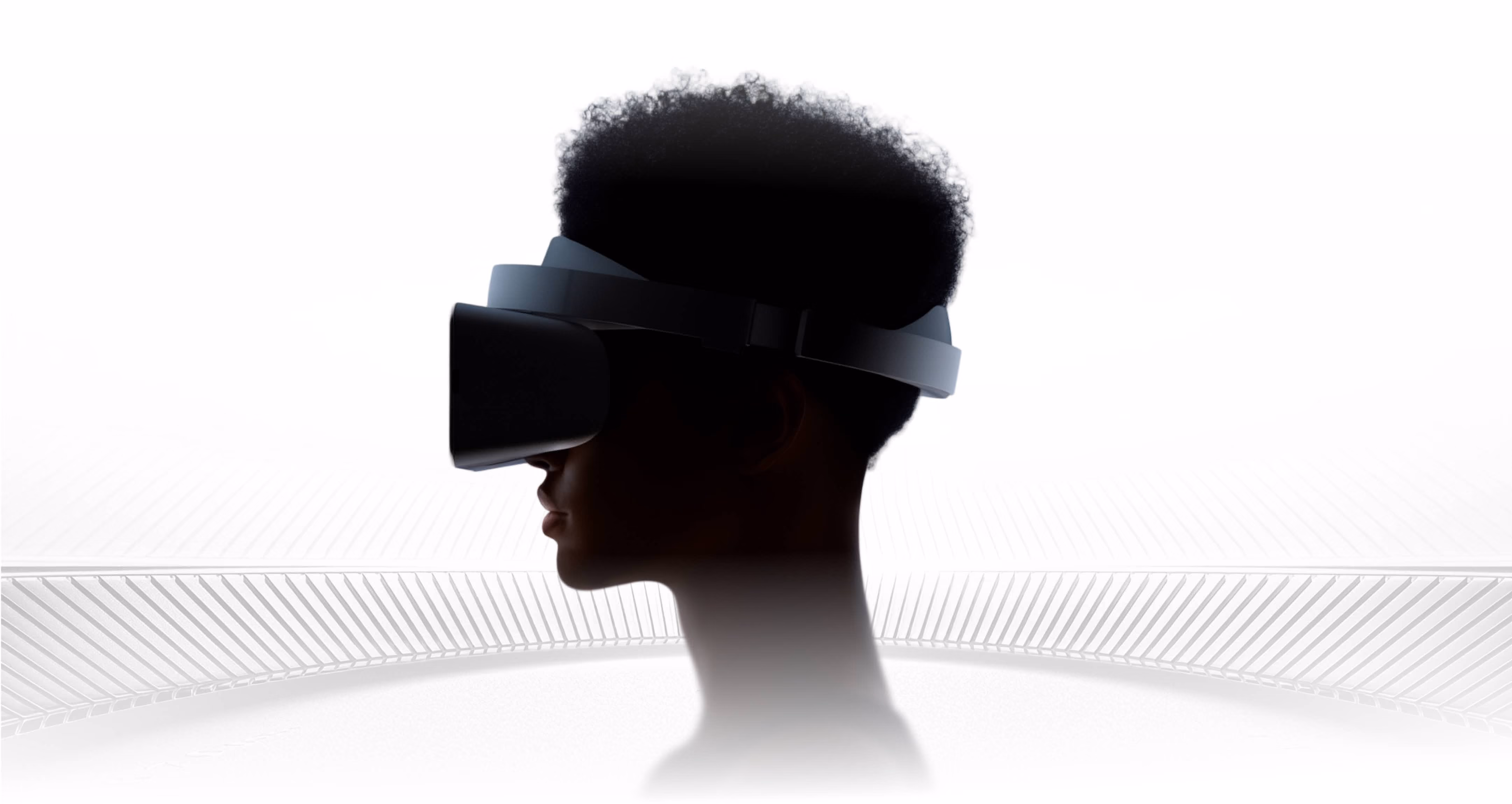 Side silhouette of a person wearing a black virtual reality headset against a white background.