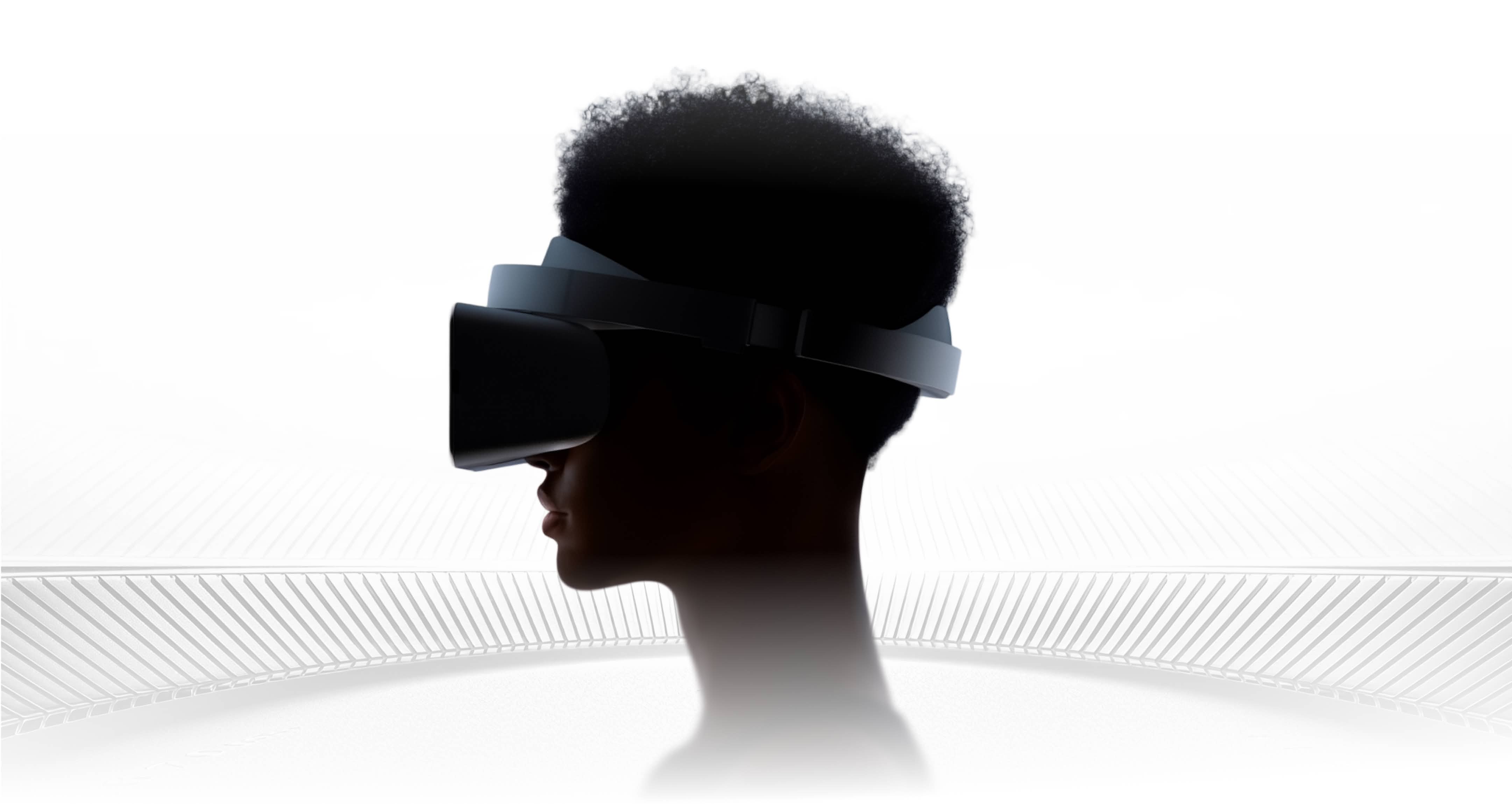 Side silhouette of a person wearing a black virtual reality headset against a white background.