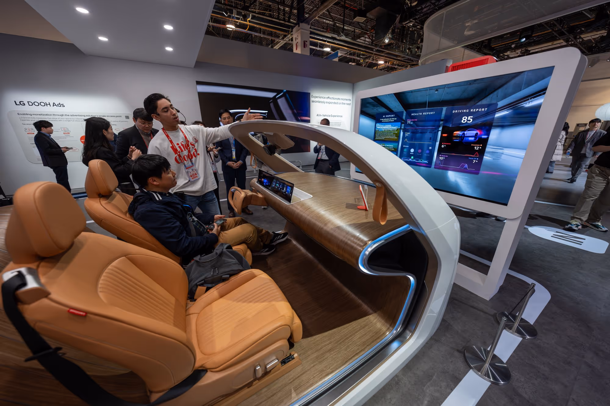 Visitors seated in an in-vehicle display demo inside a product experience center showroom.