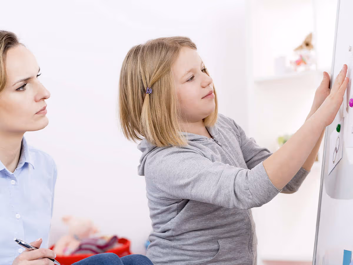 a child putting cards on a board