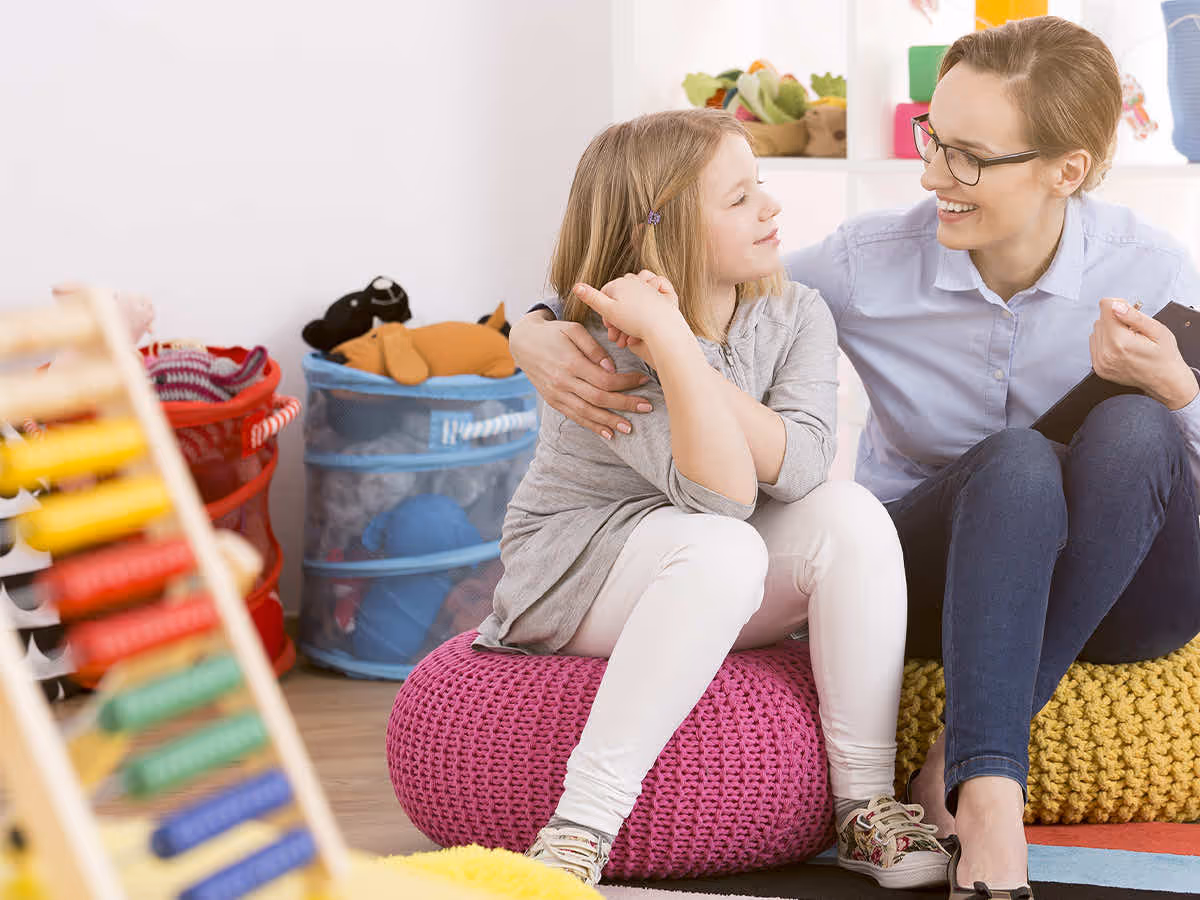 child laughing with therapist