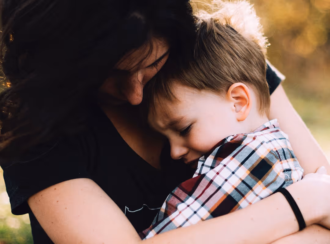 mom holding son