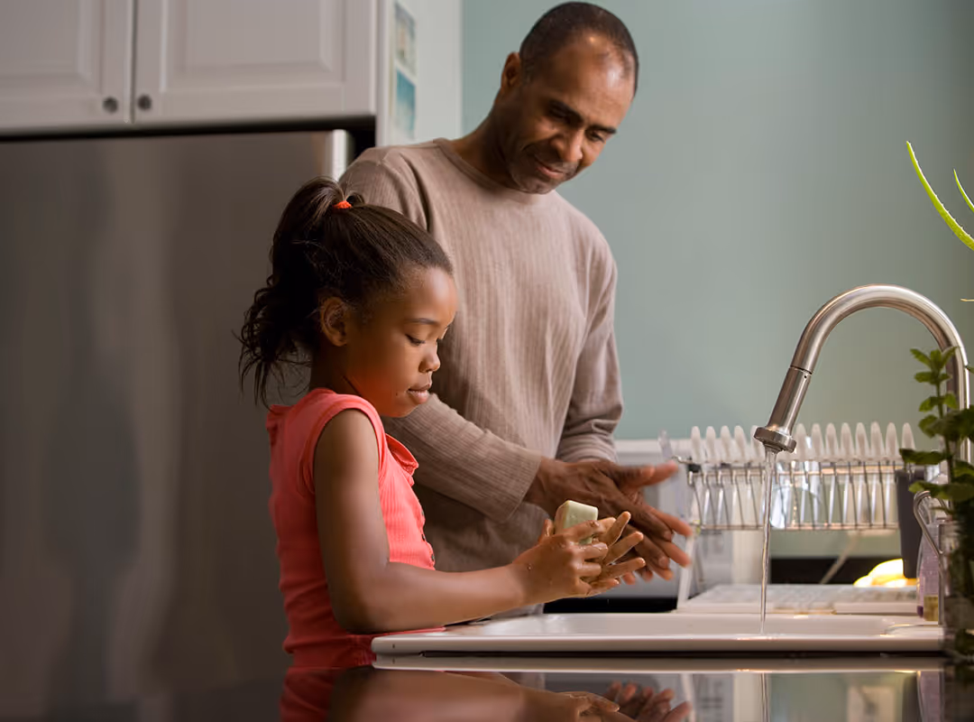 dad and daughter at the kitchen sink