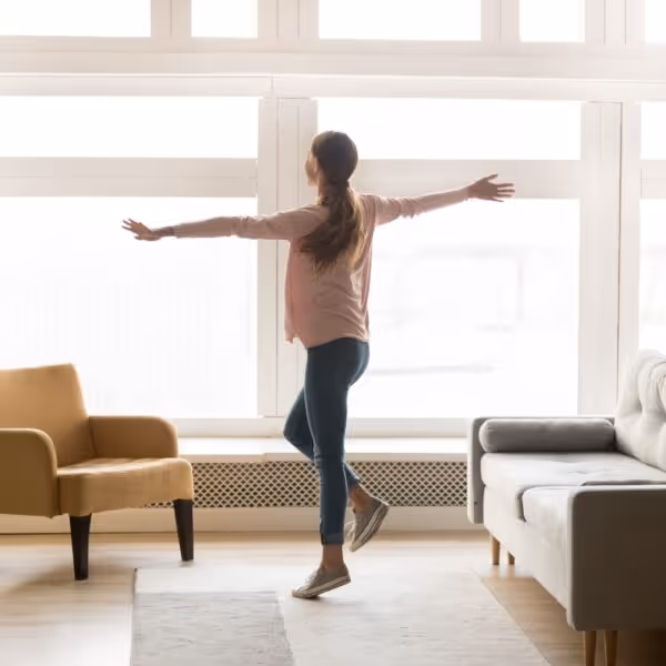 A woman dancing in her living room.