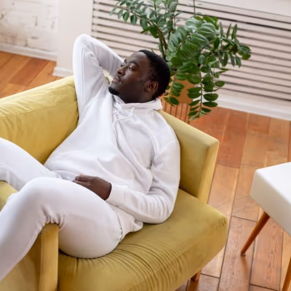 A man relaxing on his couch.