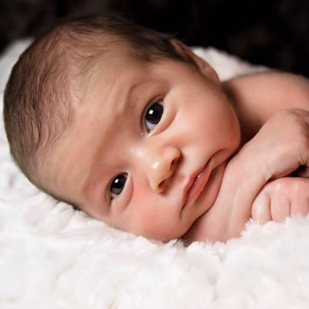 an infant looking forward
