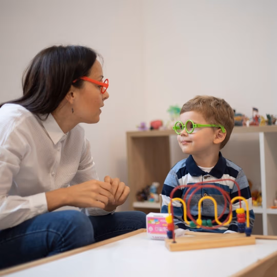 a therapist working with a little boy