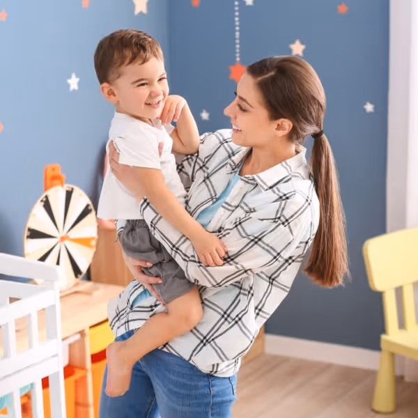 Babysitter holding a toddler