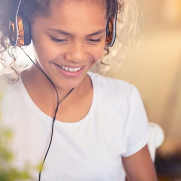 Autistic child wearing headphones to prevent sensory overload.