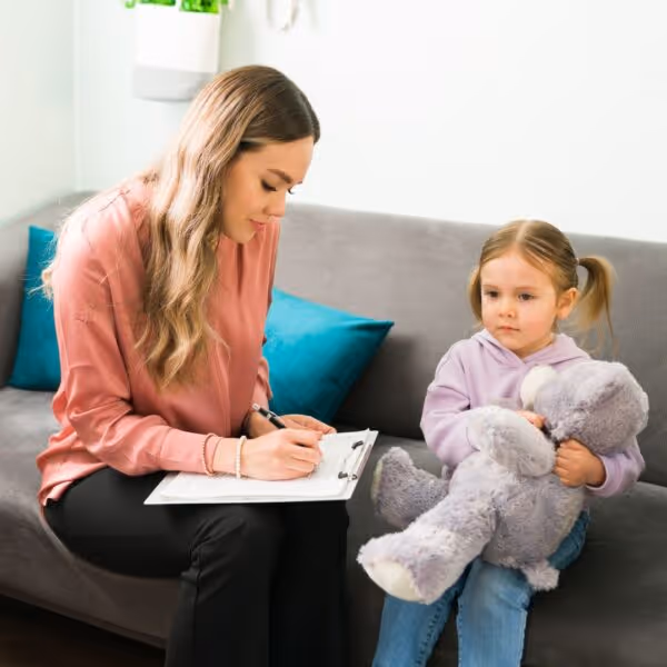 woman takes notes from a little girl