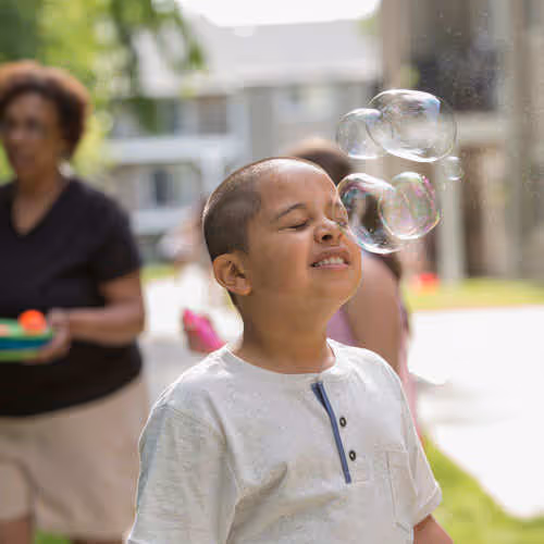 young boy playing with bubbles