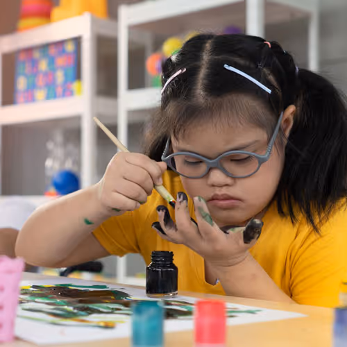 young child painting fingers