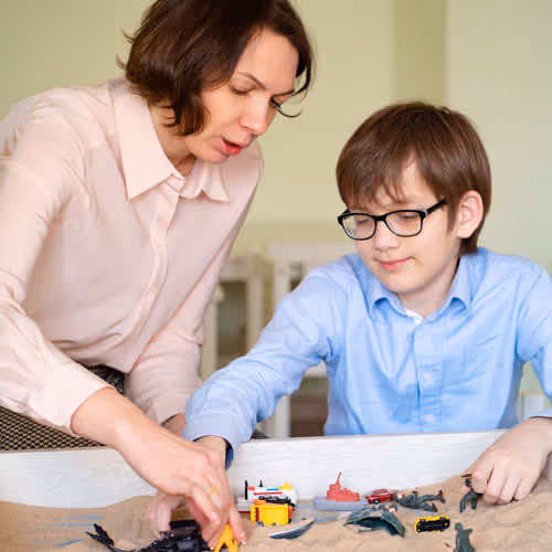 child and therapist working together
