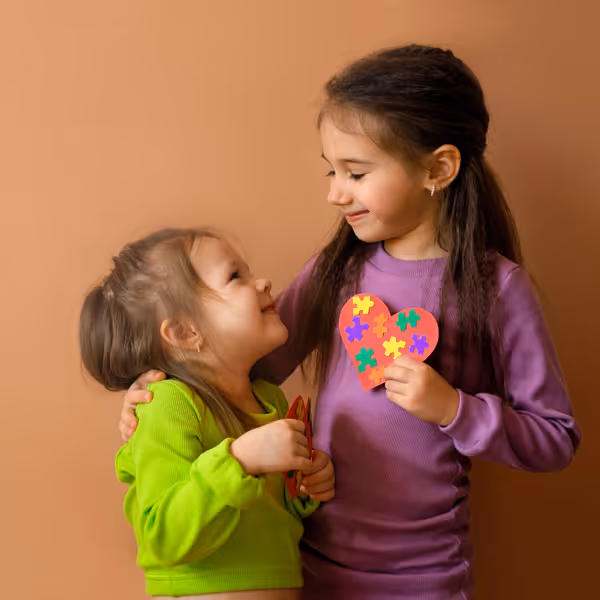 sisters holding a heart