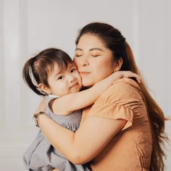 a child not engaging with their mother while being hugged