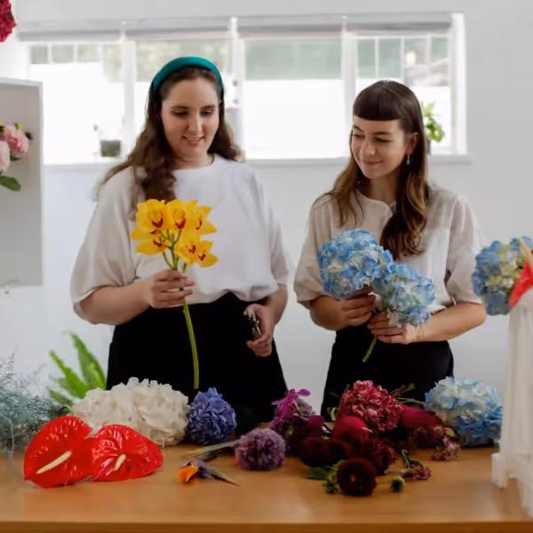 a person with autism working with colleges in a flower shop
