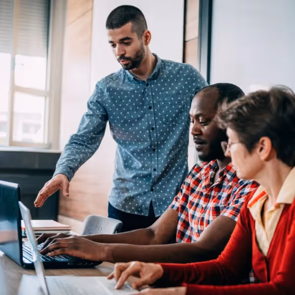 a group of people working together on a computer