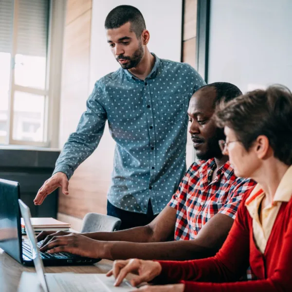 a group of people working together on a computer