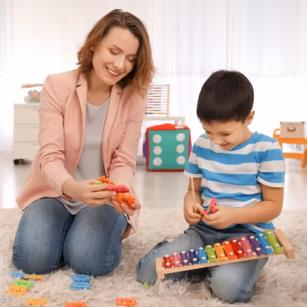 a child playing with toys with an adult