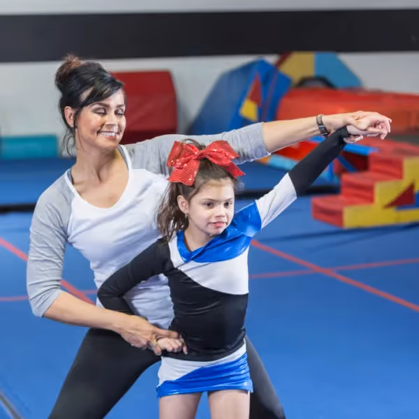 a parent helping a child cheer