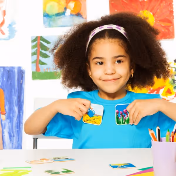 little girl holding photos