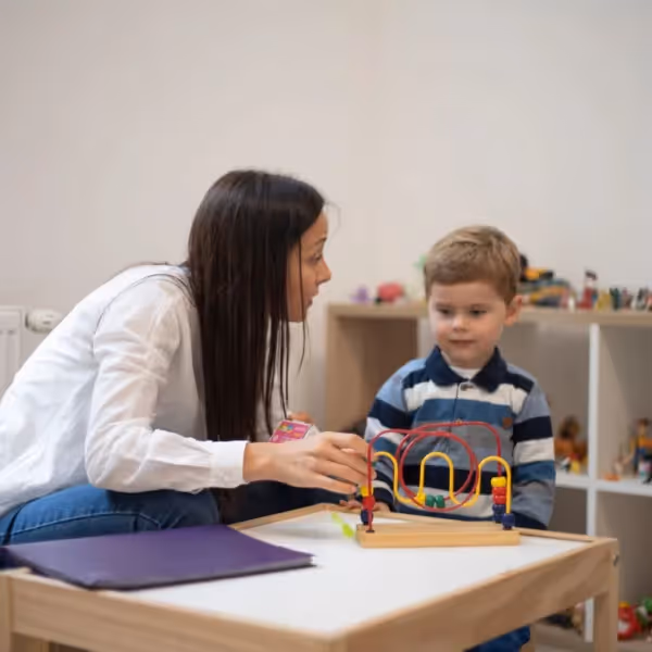 woman showing boy how to play