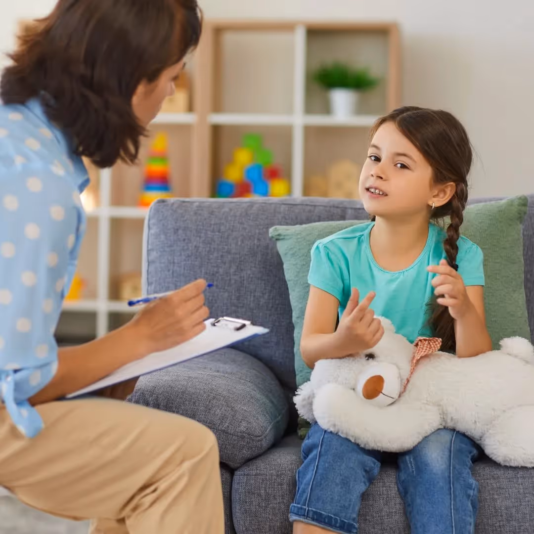 therapist taking notes during session with child