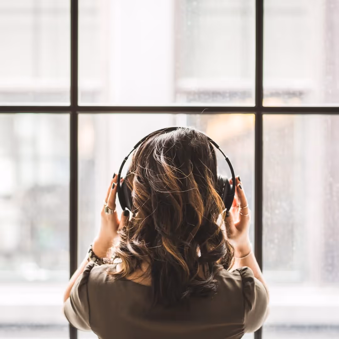A person wearing headphones seen from the back