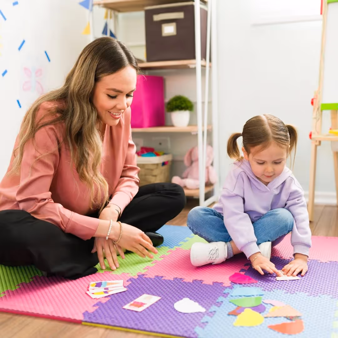 A person and a child playing with colorful shape cutouts