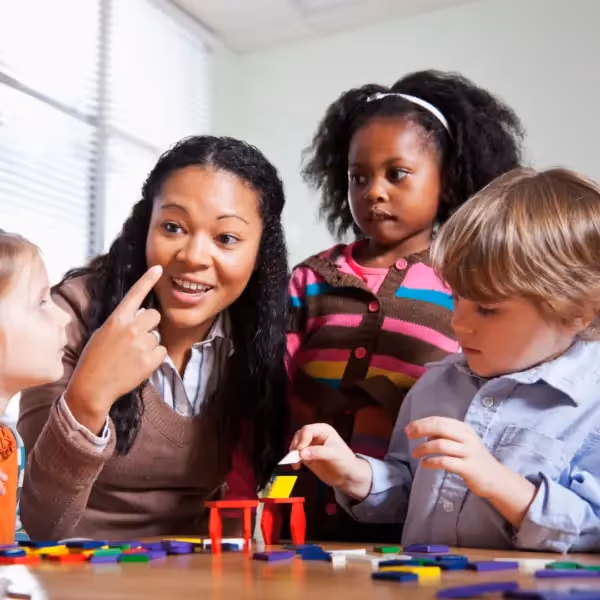 a teacher talking with a group of children