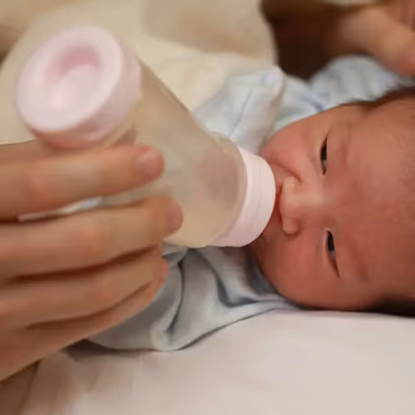 a newborn drinking from a bottle