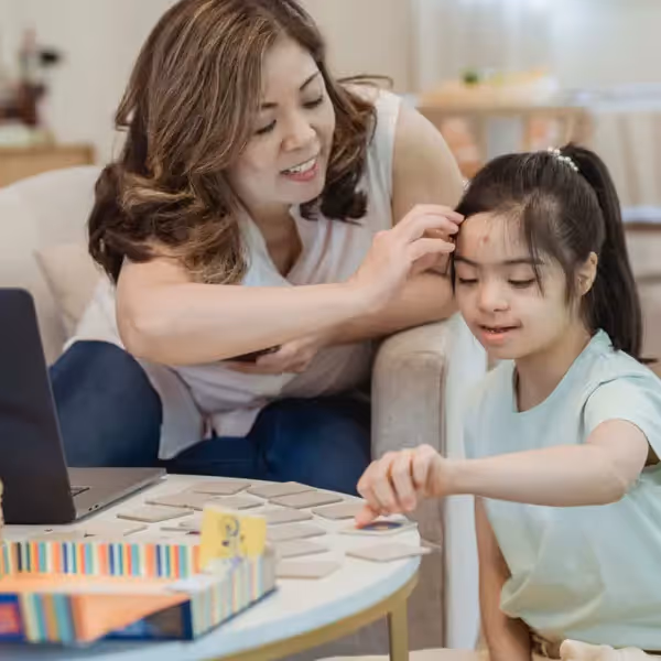 a mother working on memory tiles with her daughter