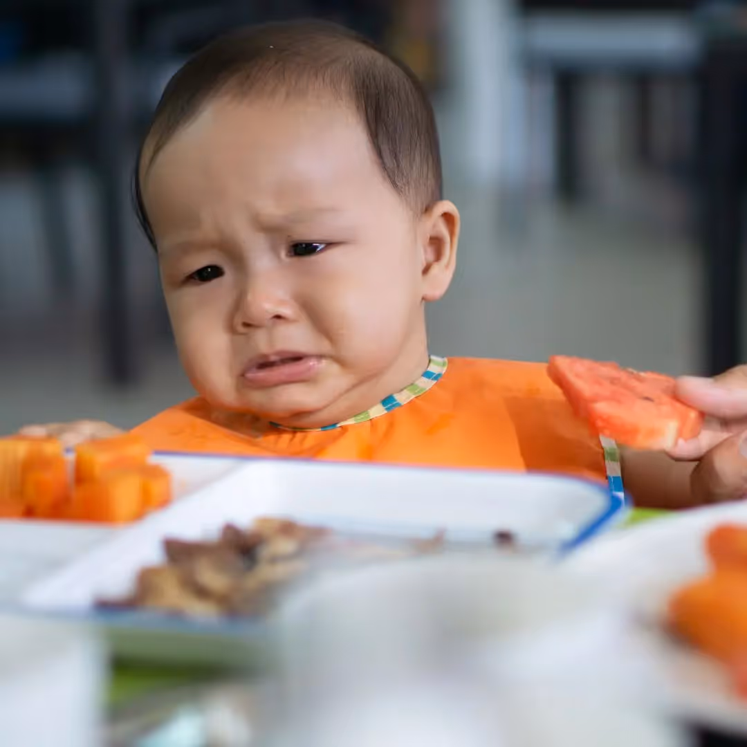 baby at table starting to cry
