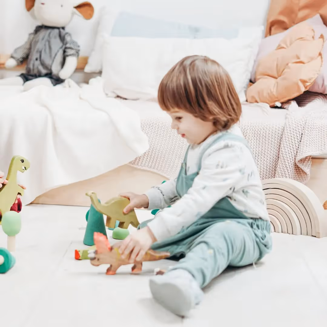 Young child playing a game with dinosaurs.