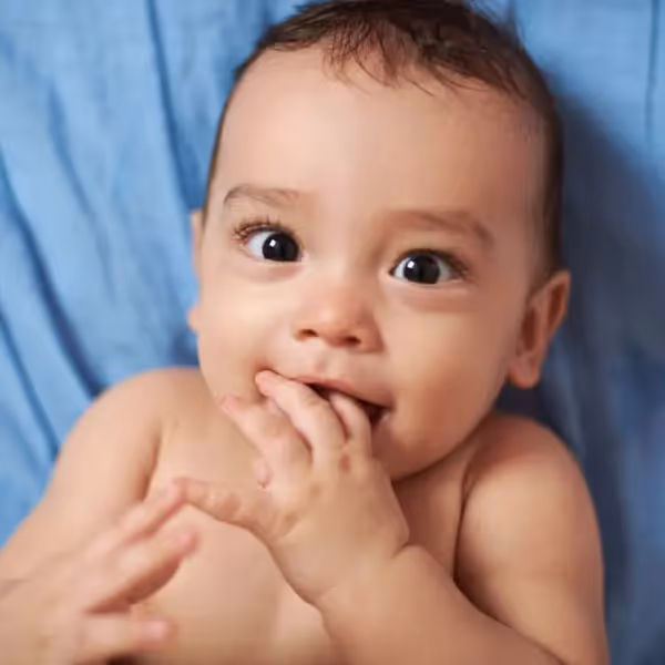 a baby sucking on its fingers