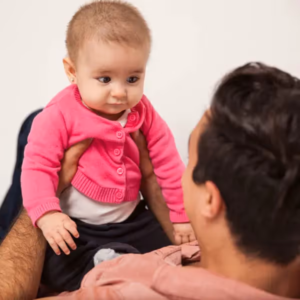 a baby looking at her father