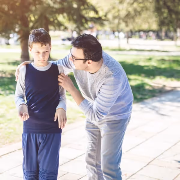 parent guiding autistic child