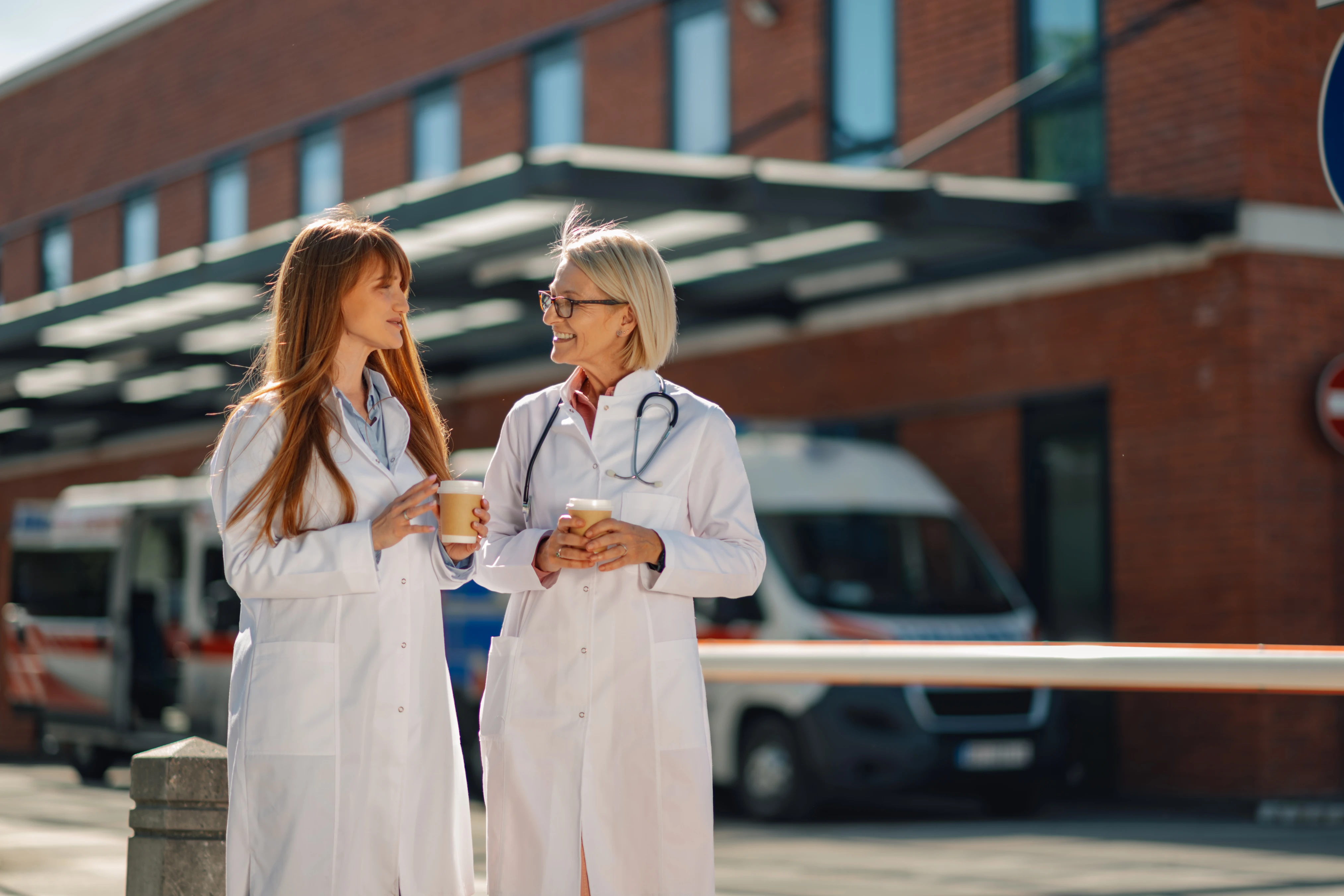 Physicians taking a break outside hospital discussing patient outcomes