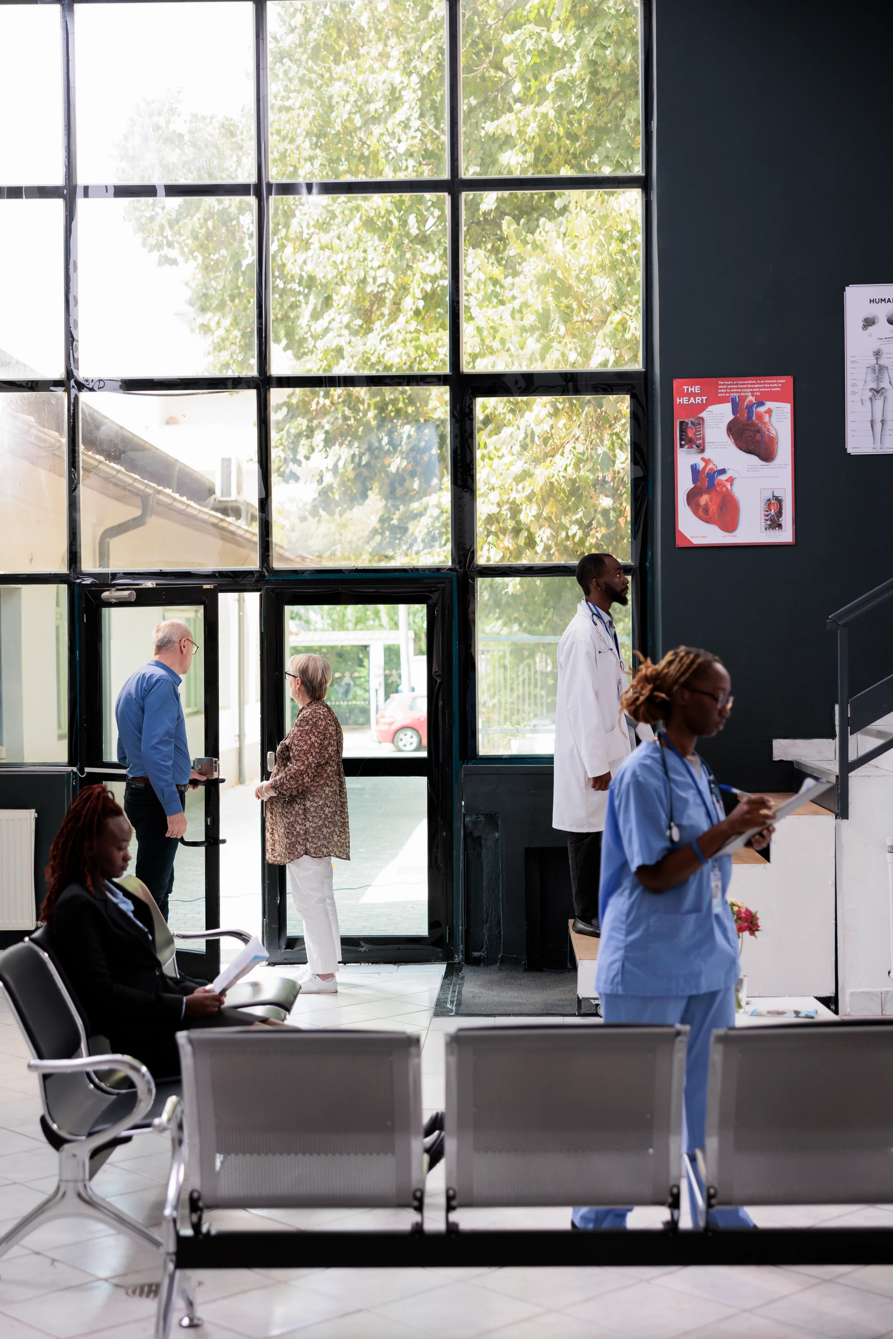 Patients and staff in hospital waiting area during check-in process