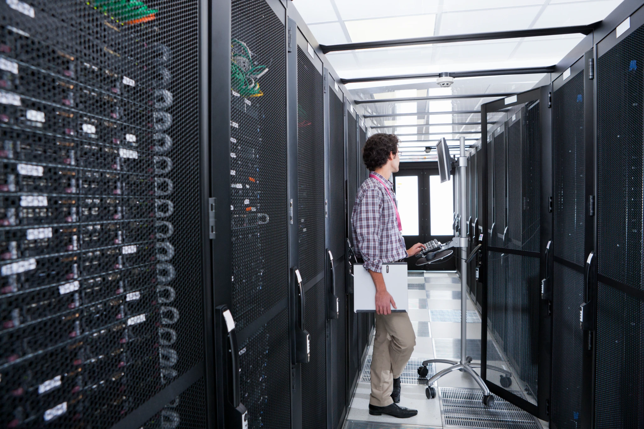 IT technician maintaining hospital data center server infrastructure