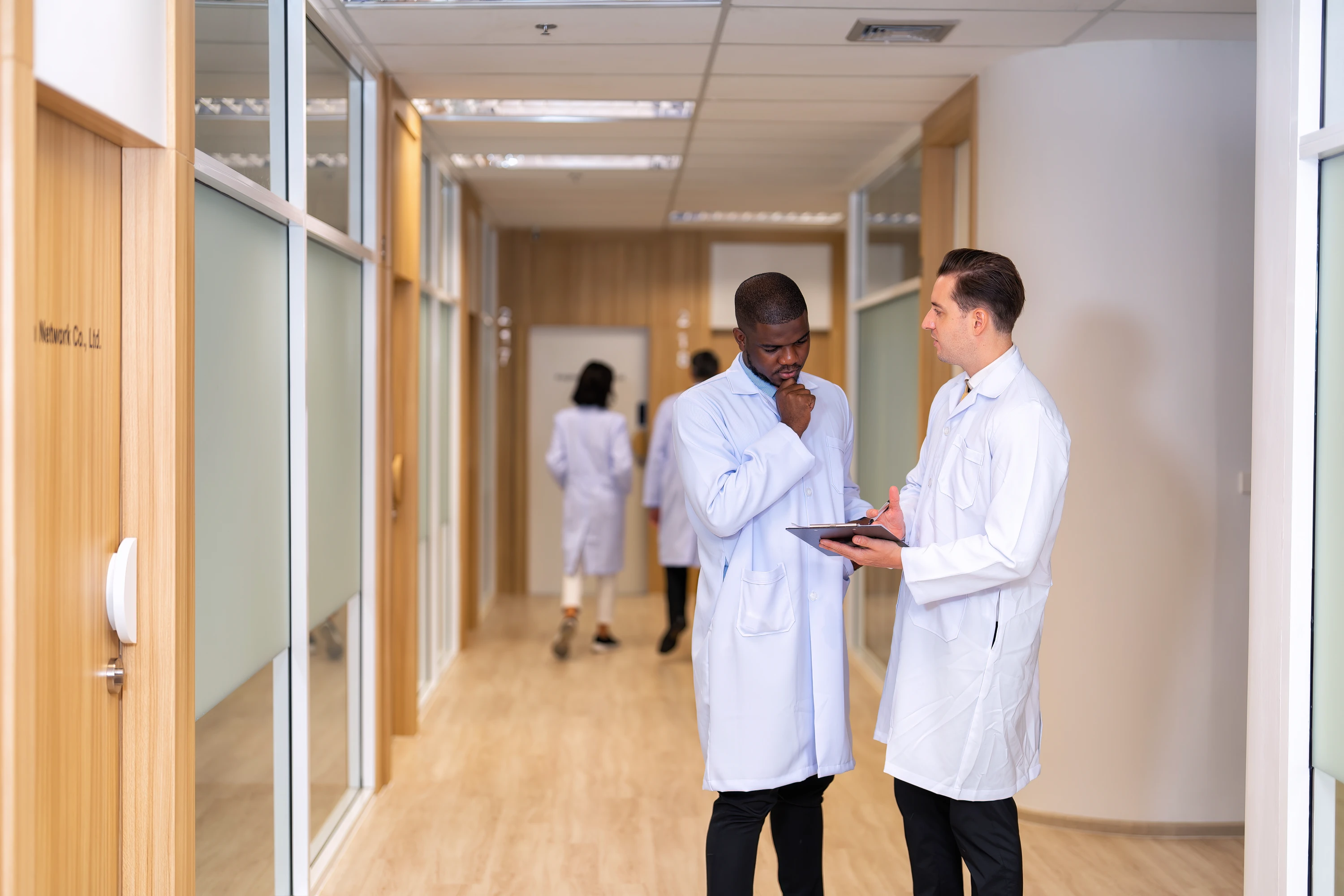 Healthcare professionals in clinical consultation at MEDITECH hospital
