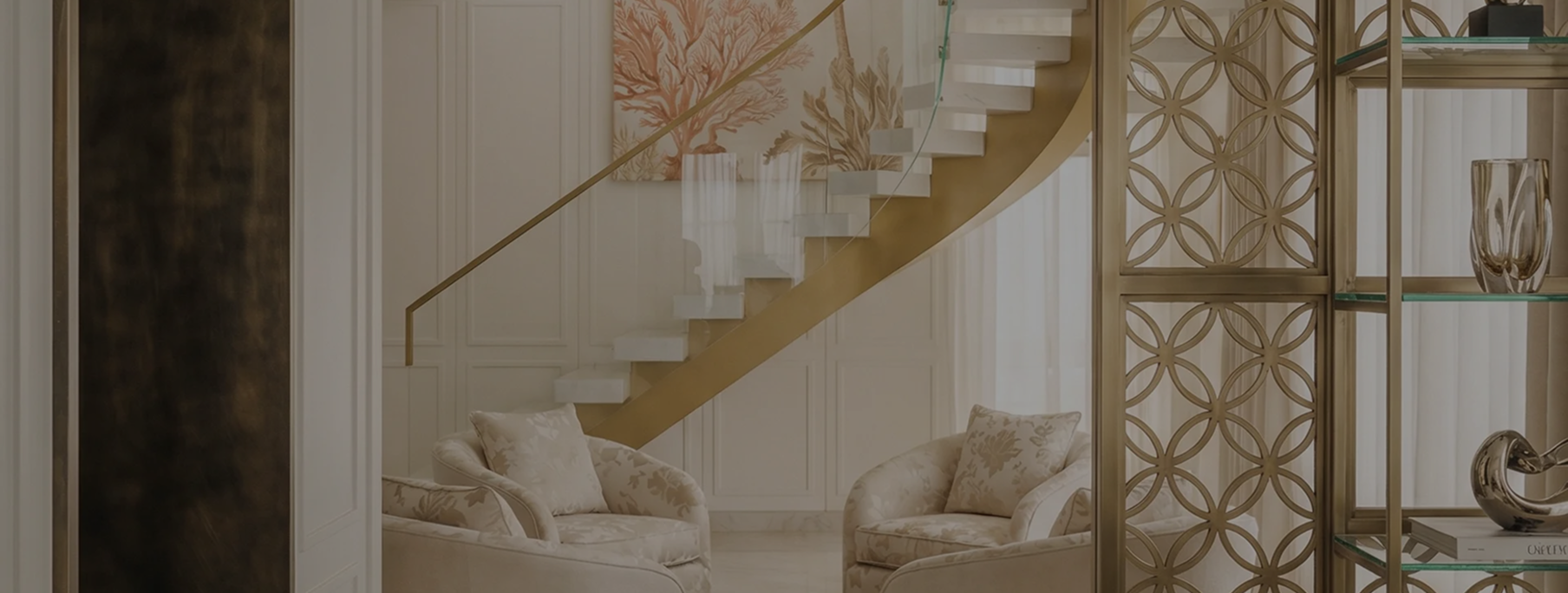 A living room filled with furniture and a stair case.