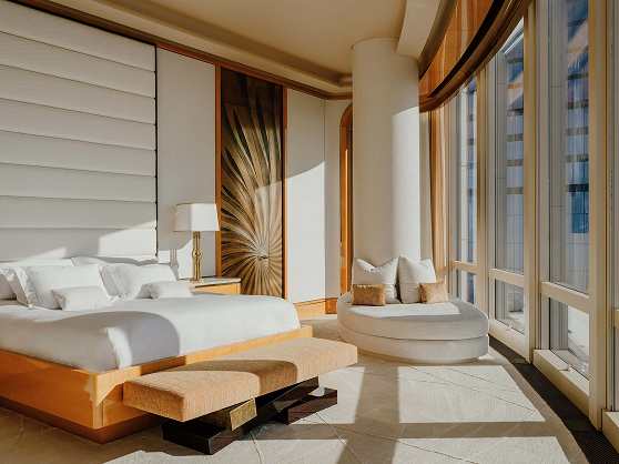 A bedroom with a large bed and a large window.