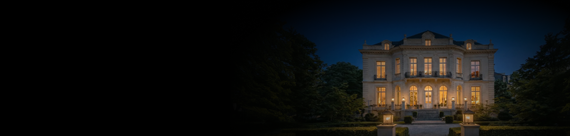 A large house lit up at night in the dark.