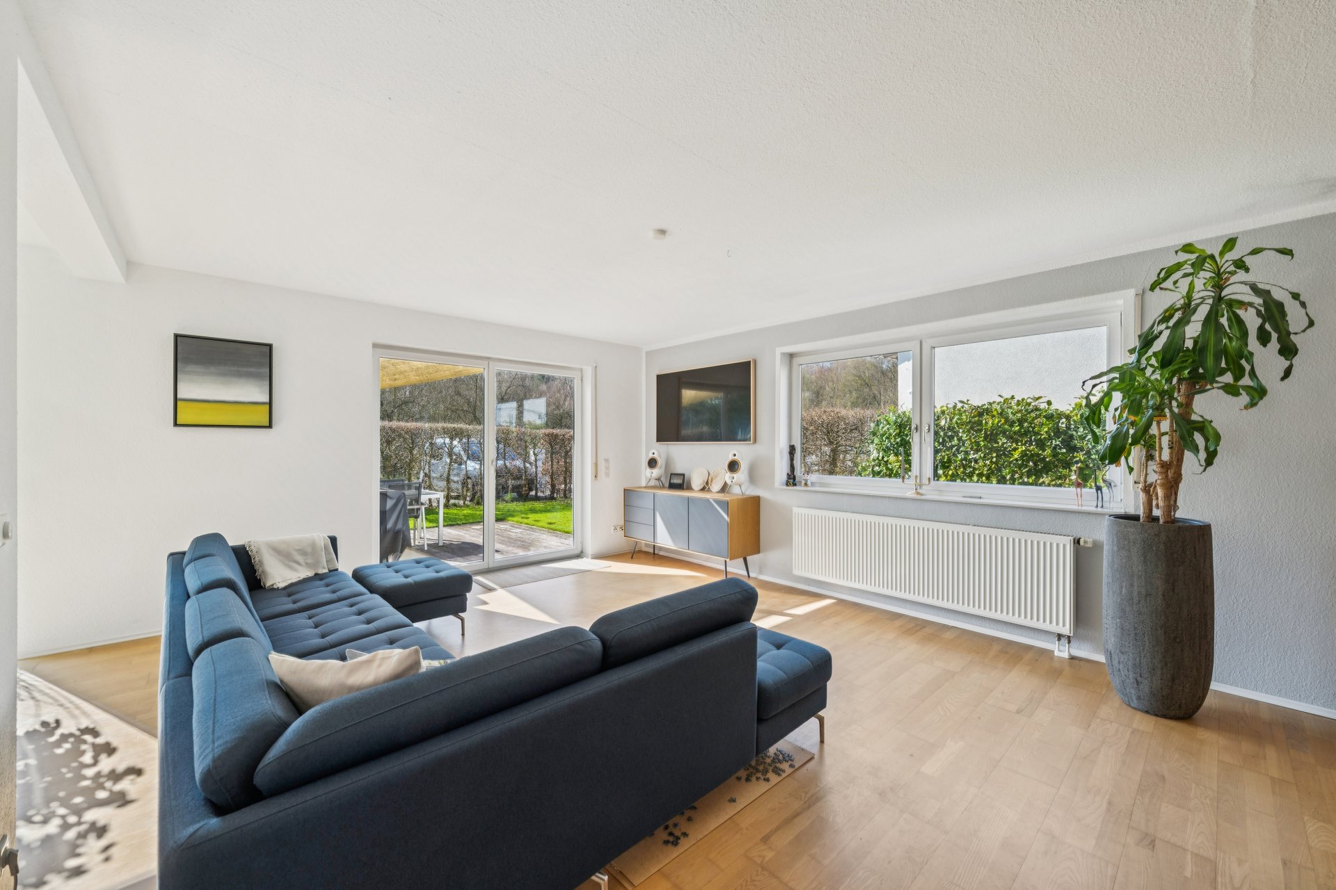 A living room filled with furniture and a large window.