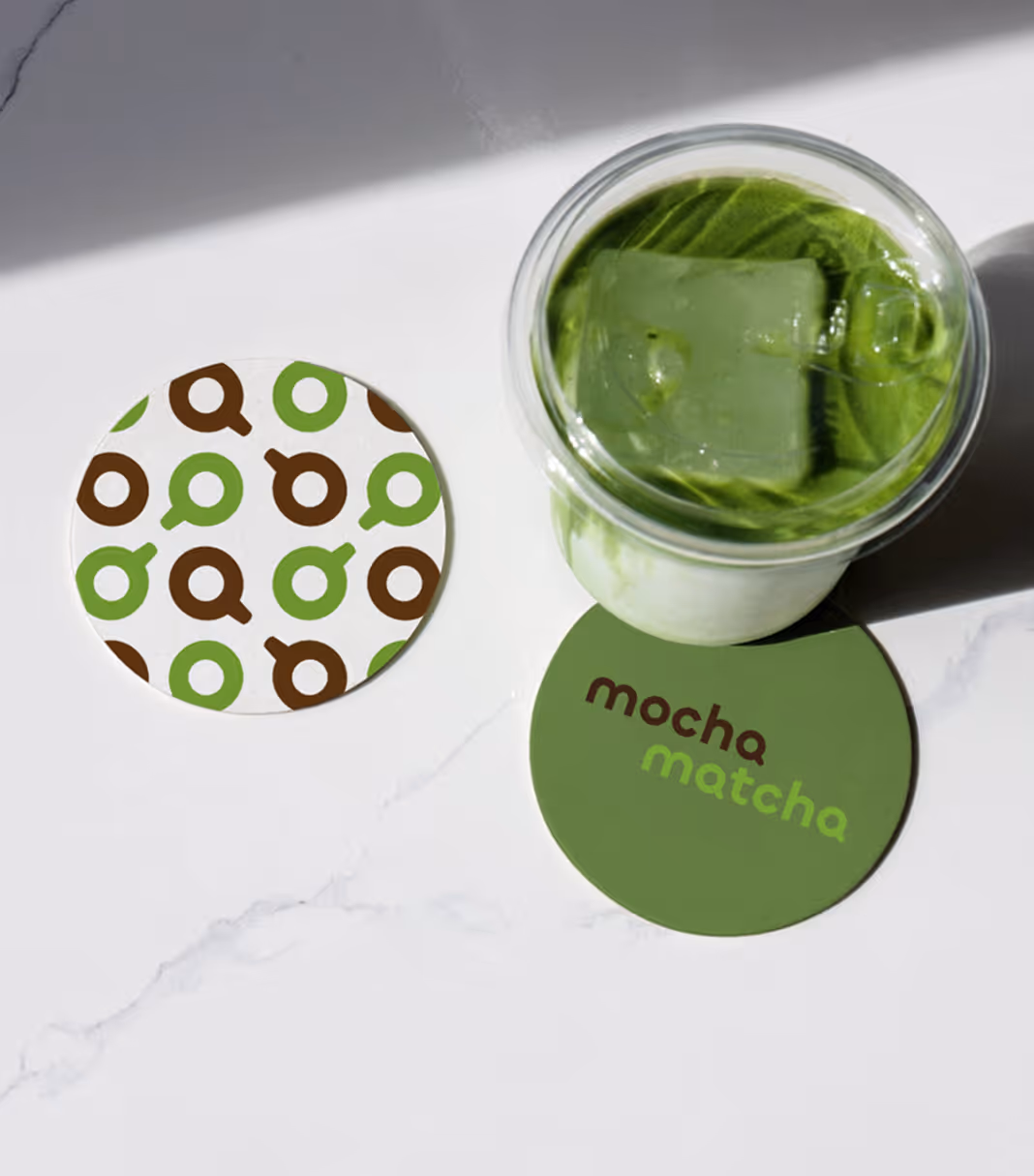 An image of a cup of matcha surrounded by 2 coasters.