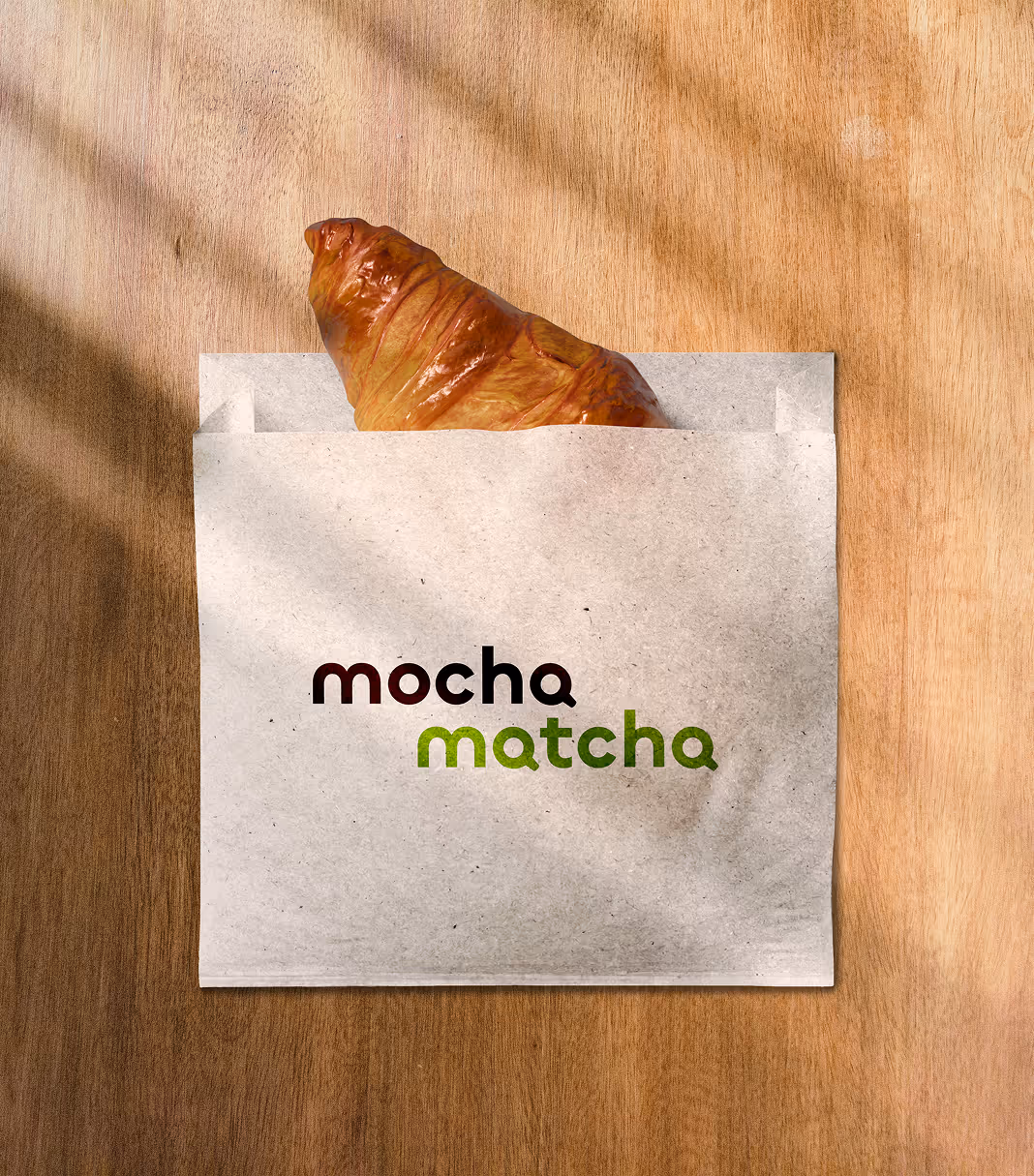 An image of a croissant sticking out of a Mocha Match wrapping paper